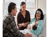 Woman breastfeeding in a hospital bed